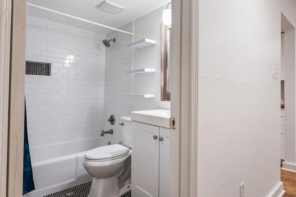 1133 Clairemont Avenue, Unit D Decatur, GA 30030 - Photo 15 of 20 a bathroom with a toilet sink and shower