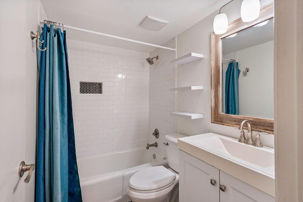 1133 Clairemont Avenue, Unit D Decatur, GA 30030 - Photo 16 of 20 a bathroom with a sink a toilet and shower