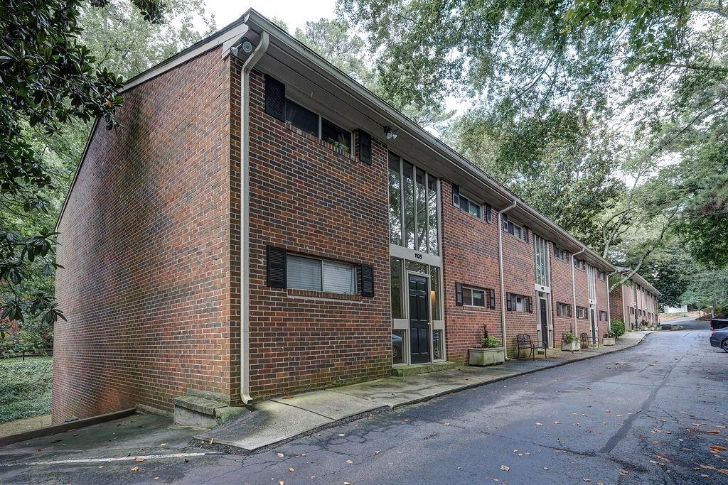1133 Clairemont Avenue, Unit D Decatur, GA 30030 - Photo 18 of 20 a front view of a house with trees