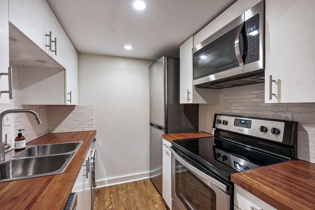 1133 Clairemont Avenue, Unit D Decatur, GA 30030 - Photo 6 of 20 a kitchen with a stove and a microwave