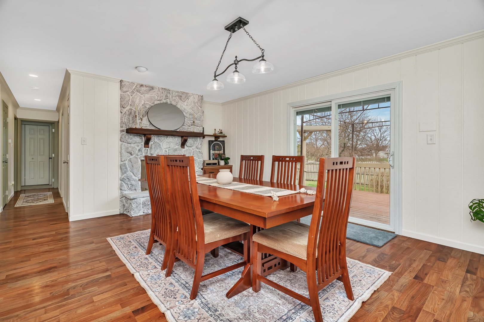 218 San Carlos Road Minooka, IL 60447 - Photo 8 of 40 a dining room with furniture a rug a potted plant and wooden floor