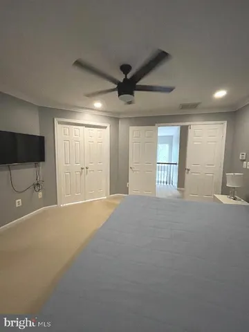 a spacious bedroom with a bed and window