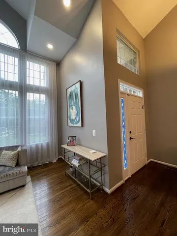a dining room with furniture a chandelier and wooden floor