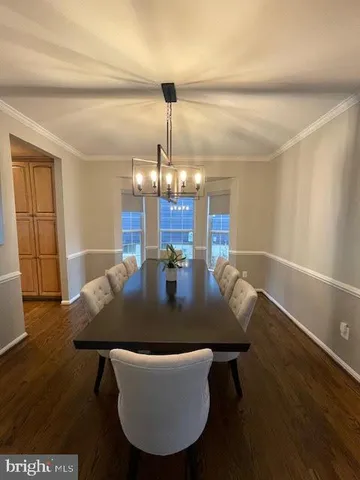 a living room with dining room and wooden floor
