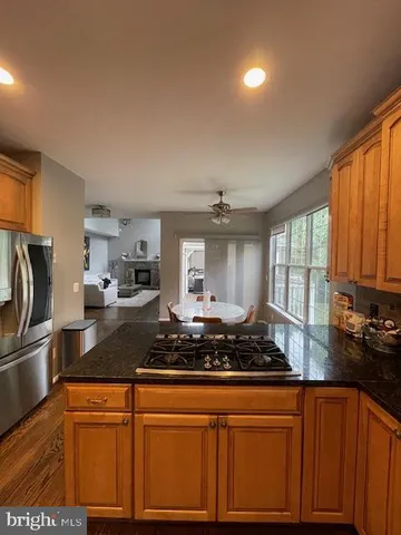 a kitchen with a table chairs stove and cabinets