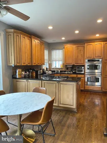 a kitchen with a table chairs and white cabinets