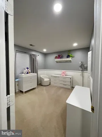 a bedroom with bed and a large mirror