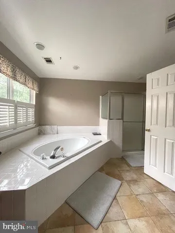 a bedroom with furniture and a wooden floor