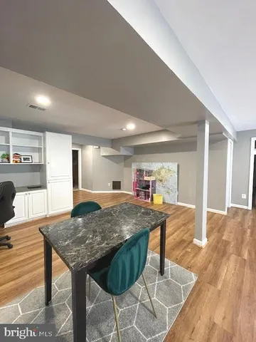 a bathroom with a granite countertop sink a toilet a shower and a mirror