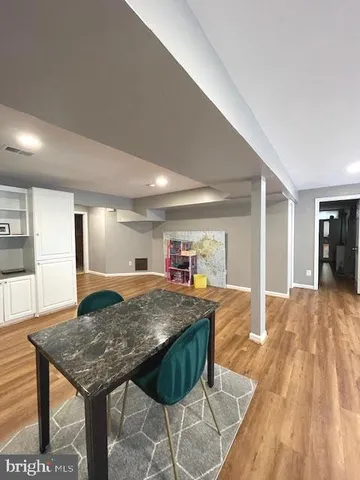 a spacious bedroom with a bed and a dresser