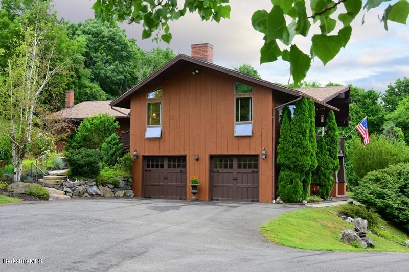 83 Sky Farm Road Copake, NY 12516 - Photo 2 of 38 a front view of a house with a yard and garage