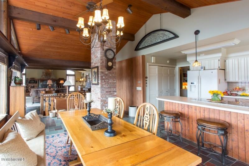 83 Sky Farm Road Copake, NY 12516 - Photo 12 of 38 a kitchen with stainless steel appliances granite countertop a sink a table and chairs