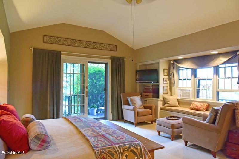 83 Sky Farm Road Copake, NY 12516 - Photo 18 of 38 a bedroom with a balcony a bed and a couch