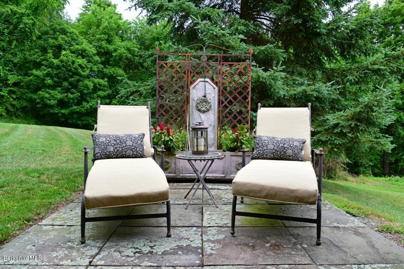 83 Sky Farm Road Copake, NY 12516 - Photo 21 of 38 a view of a patio with table and chairs and garden