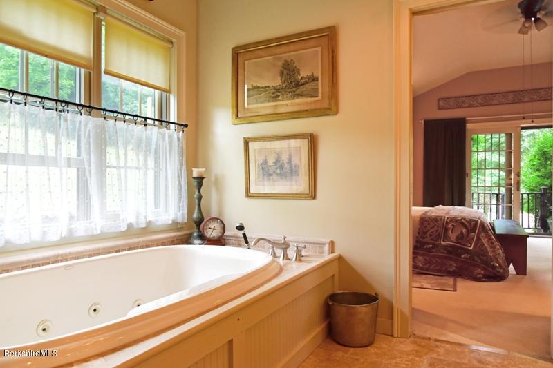 83 Sky Farm Road Copake, NY 12516 - Photo 24 of 38 a bath tub sitting next to a window