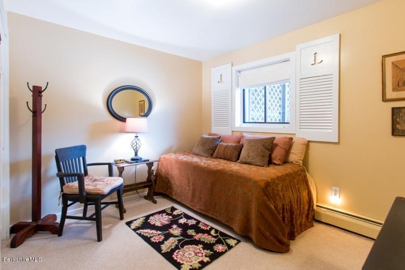83 Sky Farm Road Copake, NY 12516 - Photo 26 of 38 a bedroom with a bed window and a potted plant