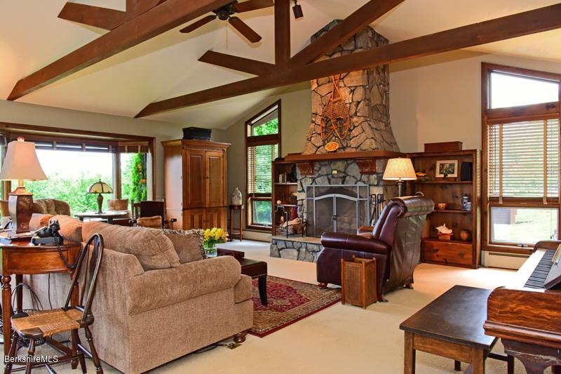 83 Sky Farm Road Copake, NY 12516 - Photo 4 of 38 a living room with fireplace furniture and a floor to ceiling window