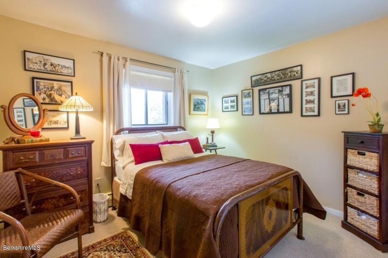 83 Sky Farm Road Copake, NY 12516 - Photo 31 of 38 a bedroom with a bed next to a window