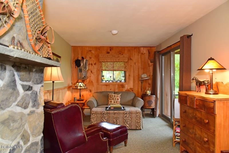 83 Sky Farm Road Copake, NY 12516 - Photo 34 of 38 a living room with furniture a window and a chandelier