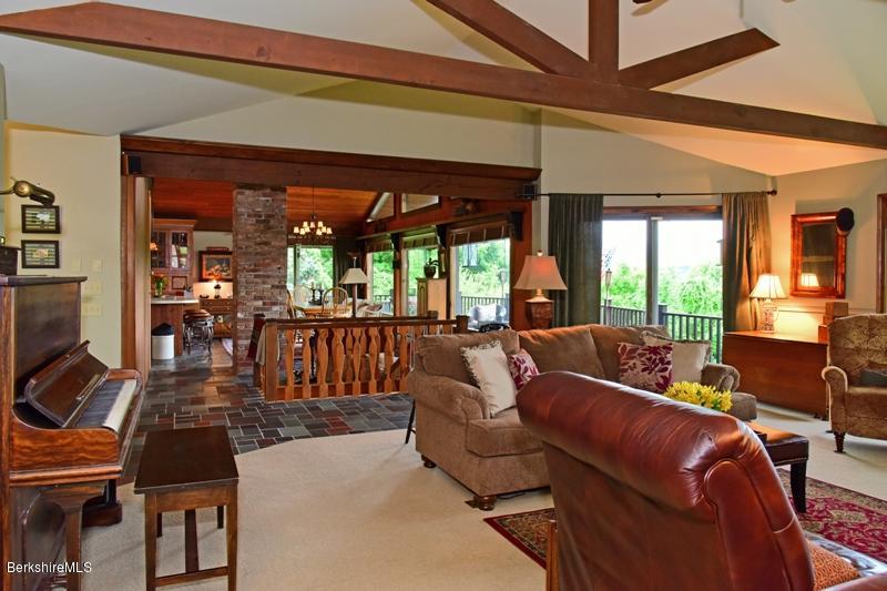 83 Sky Farm Road Copake, NY 12516 - Photo 9 of 38 a living room with furniture a floor to ceiling window and a flat screen tv