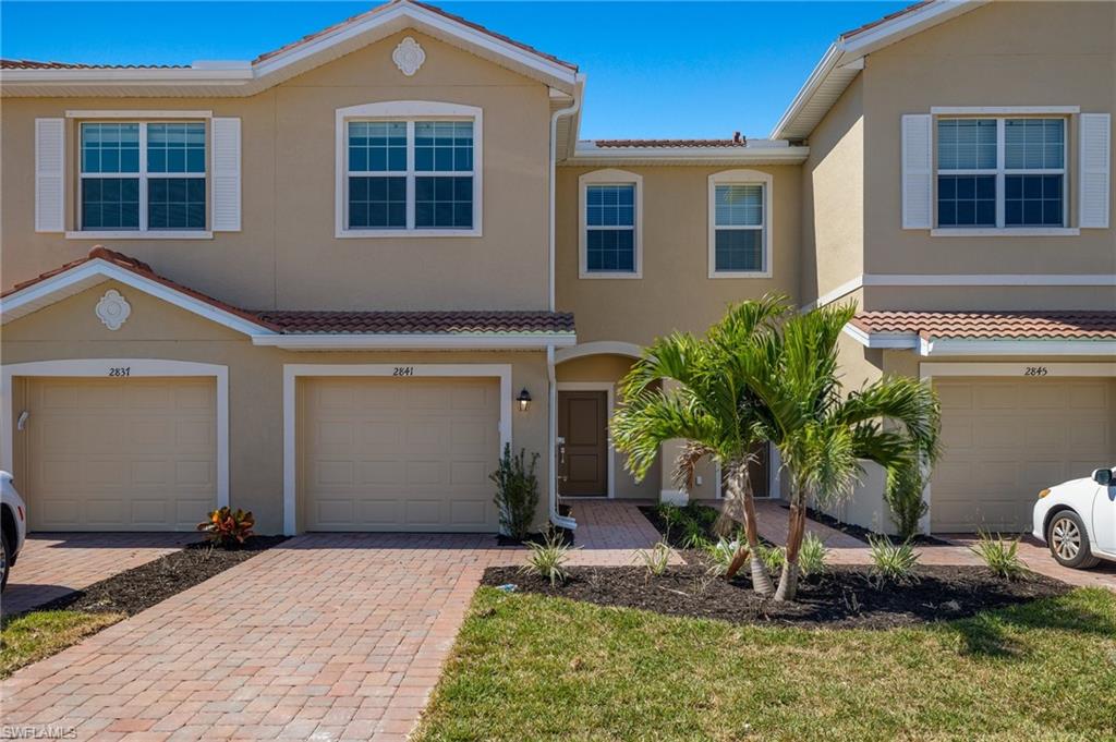2841 Citrus Street Naples, FL 34120 - Photo 6 of 28 Multi unit property featuring stucco siding, decorative driveway, and an attached garage