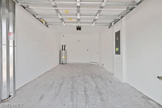 2841 Citrus Street Naples, FL 34120 - Photo 10 of 28 Garage featuring water heater, electric panel, and a garage door opener