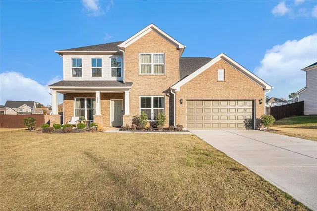 a front view of a house with a yard and garage