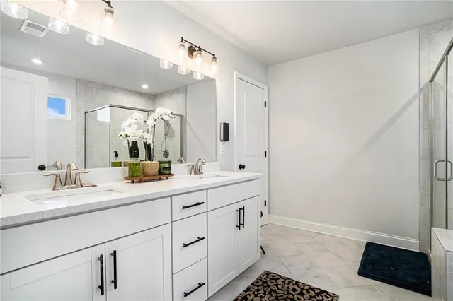 a spacious bathroom with a sink a toilet a mirror and vanity