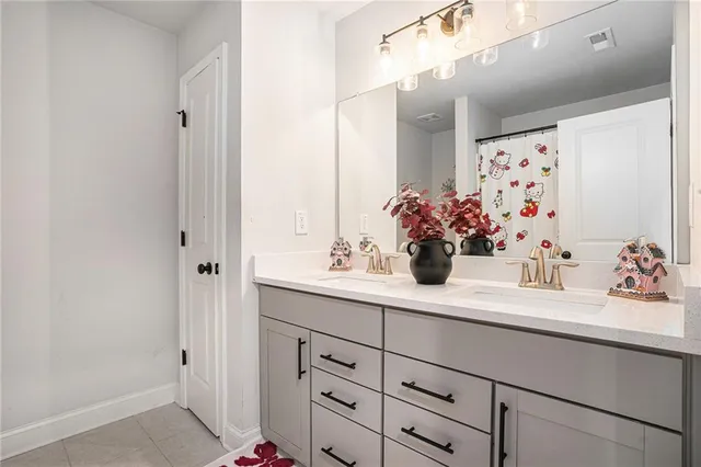 a bathroom with a sink vanity and a mirror