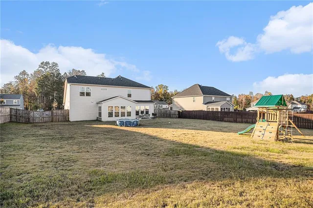 a view of a house next to a big yard