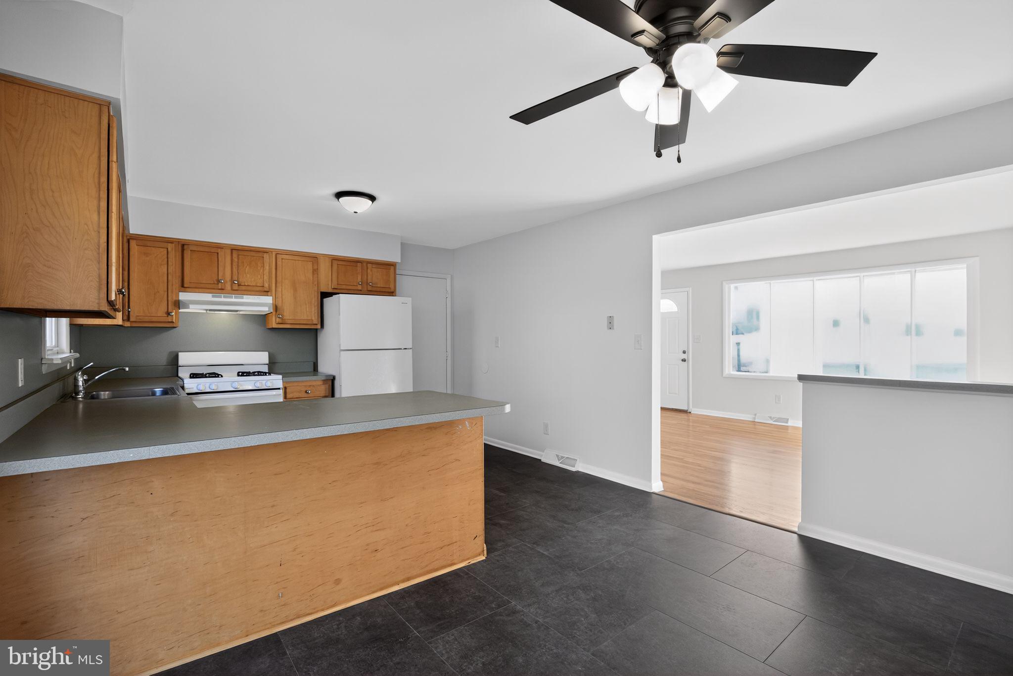 462 East Elmer Road Vineland, NJ 08360 - Photo 11 of 30 a kitchen with a stove cabinets and wooden floor