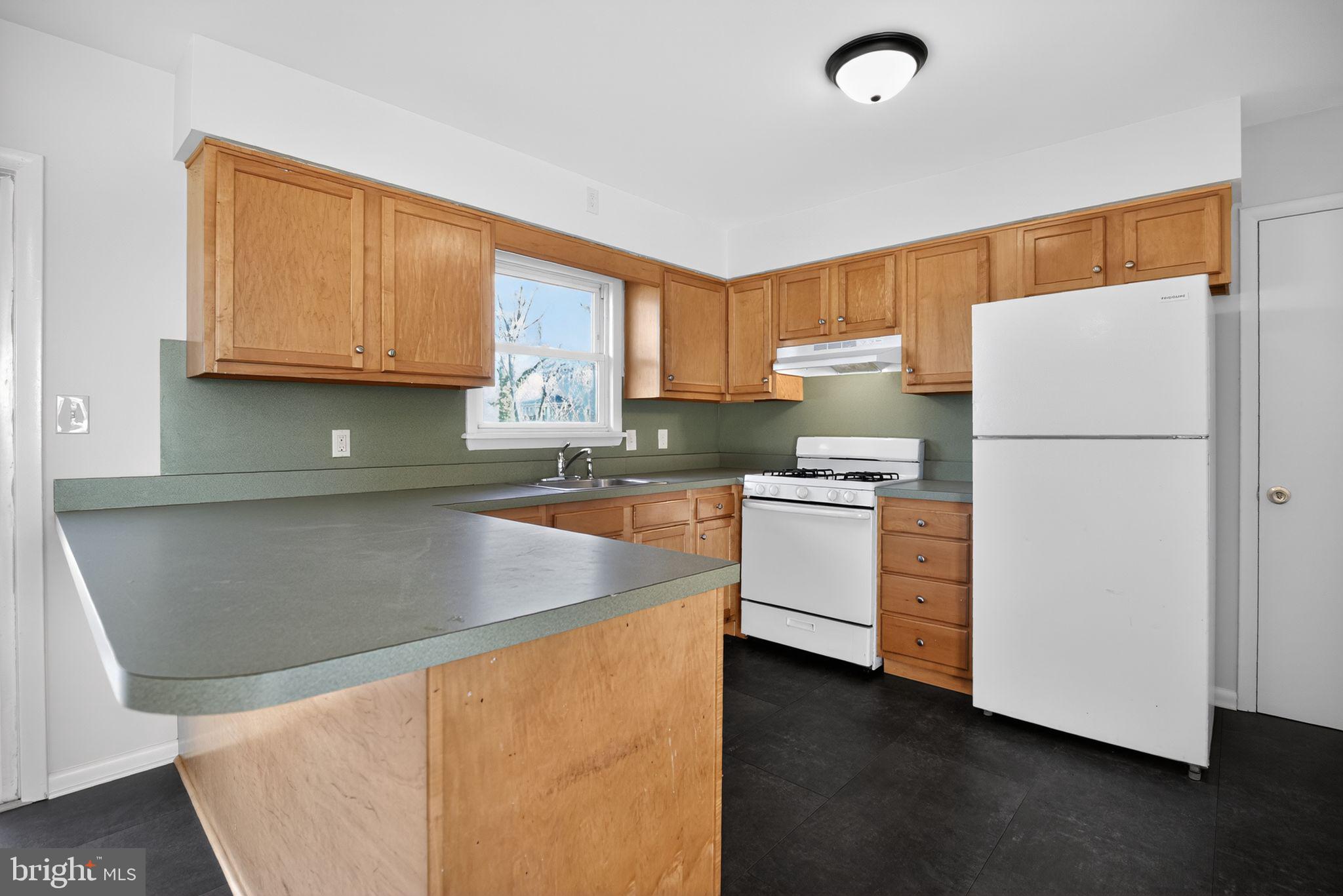462 East Elmer Road Vineland, NJ 08360 - Photo 12 of 30 a kitchen with granite countertop a sink stove and refrigerator