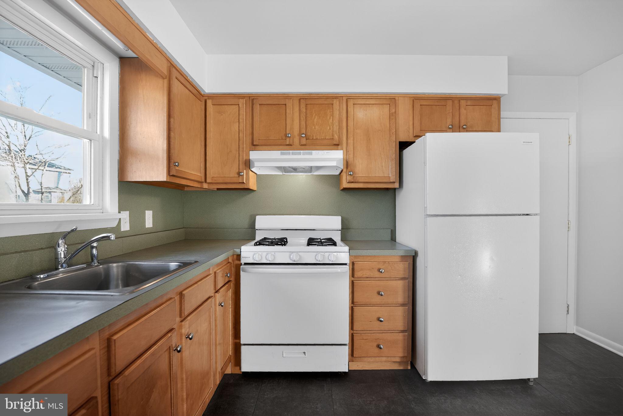 462 East Elmer Road Vineland, NJ 08360 - Photo 14 of 30 a kitchen with cabinets appliances and a sink
