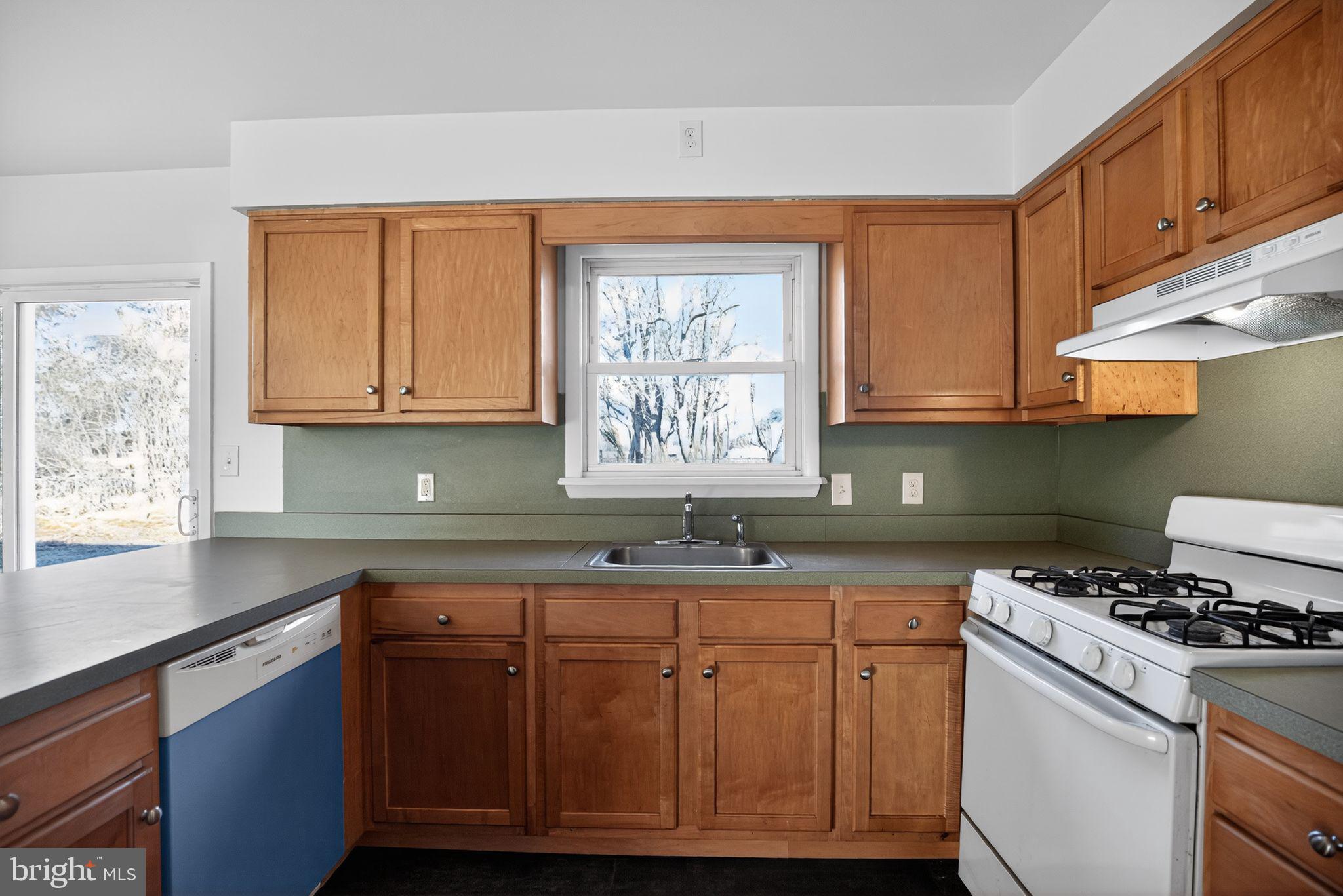 462 East Elmer Road Vineland, NJ 08360 - Photo 15 of 30 a kitchen with granite countertop a sink a stove cabinets and wooden floor
