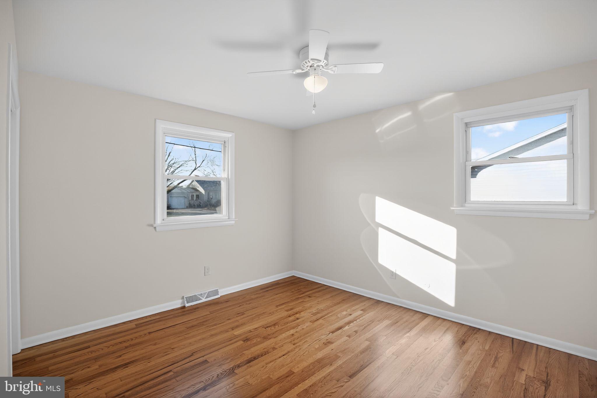 462 East Elmer Road Vineland, NJ 08360 - Photo 20 of 30 a view of empty room with wooden floor and fan