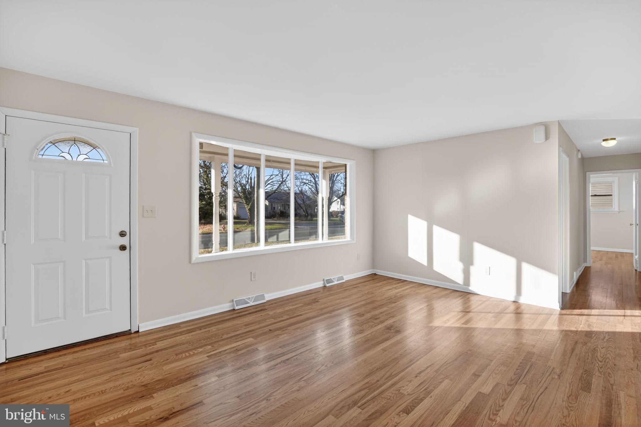462 East Elmer Road Vineland, NJ 08360 - Photo 2 of 30 a view of an empty room with wooden floor and a window