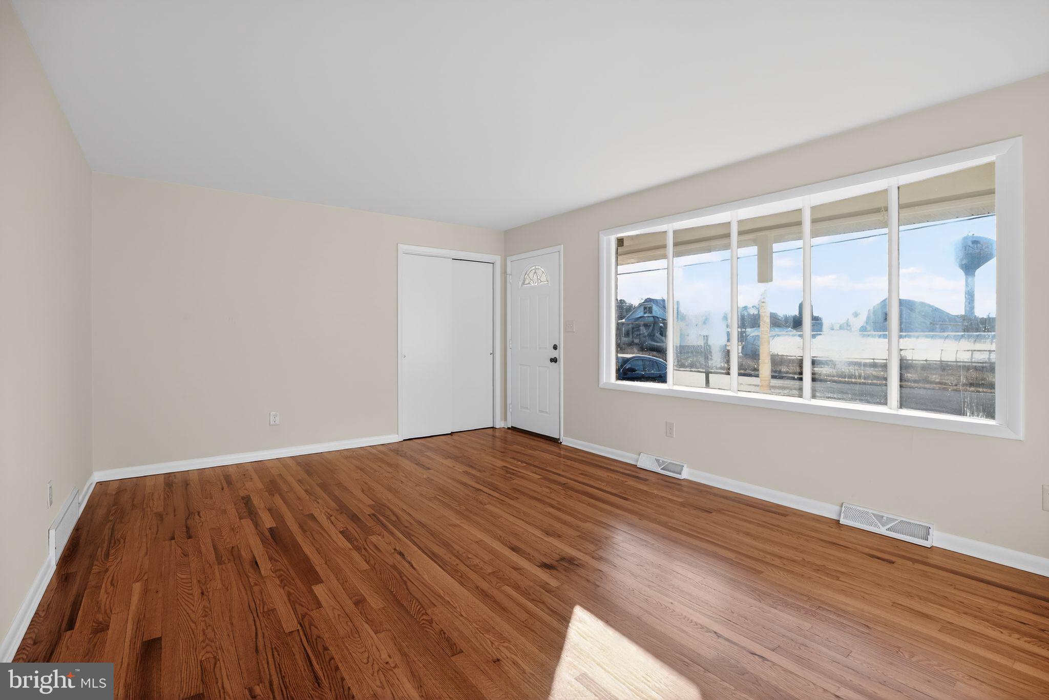 462 East Elmer Road Vineland, NJ 08360 - Photo 3 of 30 a view of empty room with wooden floor and fan
