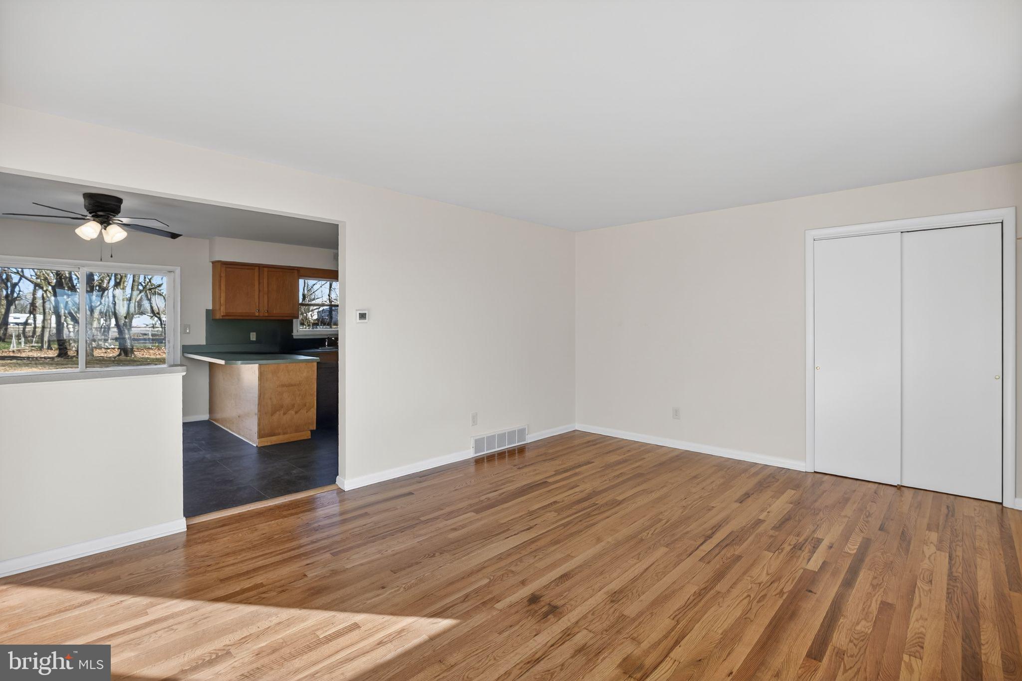 462 East Elmer Road Vineland, NJ 08360 - Photo 6 of 30 a view of a livingroom with wooden floor and kitchen view