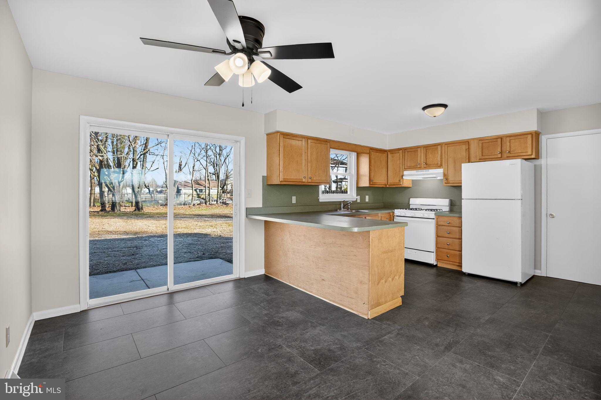 462 East Elmer Road Vineland, NJ 08360 - Photo 8 of 30 a kitchen with refrigerator cabinets and window