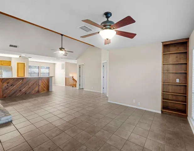 a view of a livingroom with a furniture ceiling fan and window