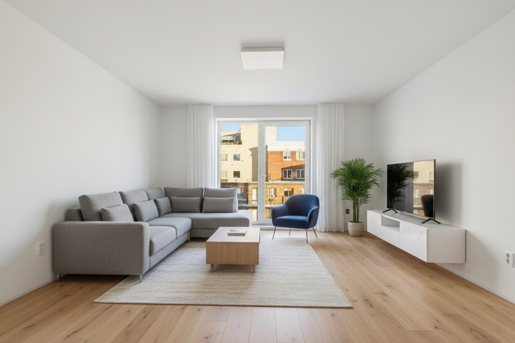 1035 Commonwealth Avenue, Unit 404 Boston, MA 02215 - Photo 3 of 11 a living room with furniture and a flat screen tv