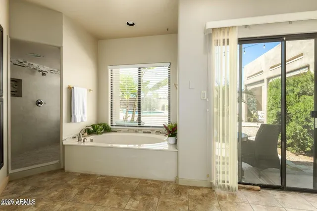 a bathroom with a bathtub and shower