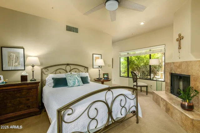 a bedroom with a bed and a fireplace