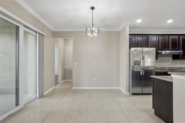 a view of a kitchen with refrigerator and a sink