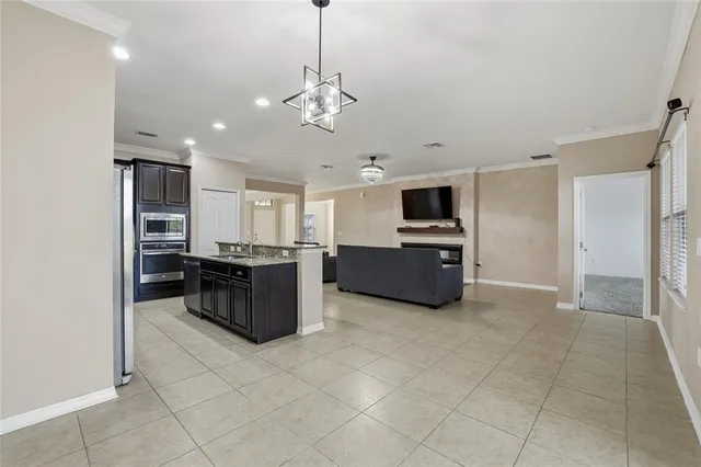 a large kitchen with a stove and a refrigerator