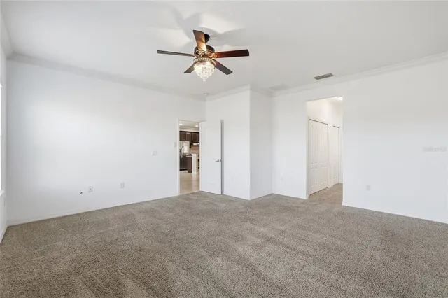 a view of a livingroom with a ceiling fan and window