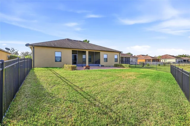 a view of a house with a yard and sitting area