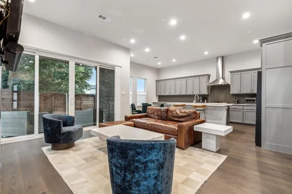 a kitchen with a refrigerator a sink dishwasher with a dining table and chairs