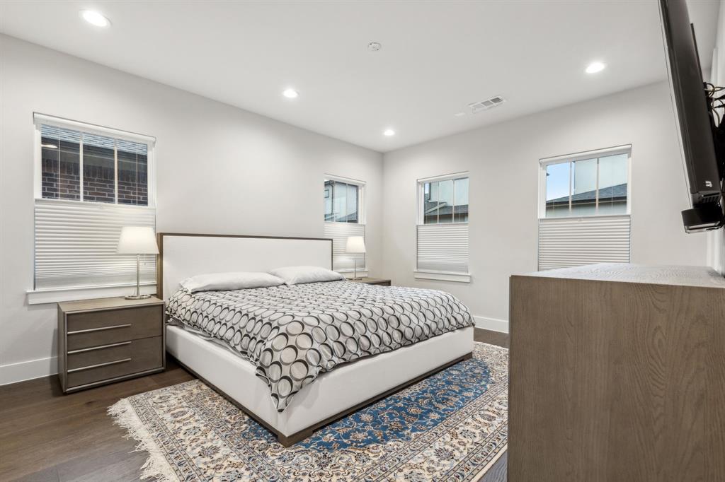 4109 Maison Ridge Dallas, TX 75219 - Photo 15 of 39 a bedroom with a bed and a night stand