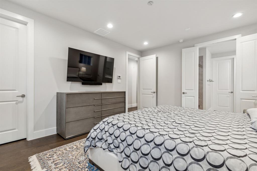 4109 Maison Ridge Dallas, TX 75219 - Photo 17 of 39 a bedroom with a bed and a flat screen tv